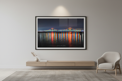 Large fine art landscape print of illuminated Mackinac Bridge at night displayed in modern living room