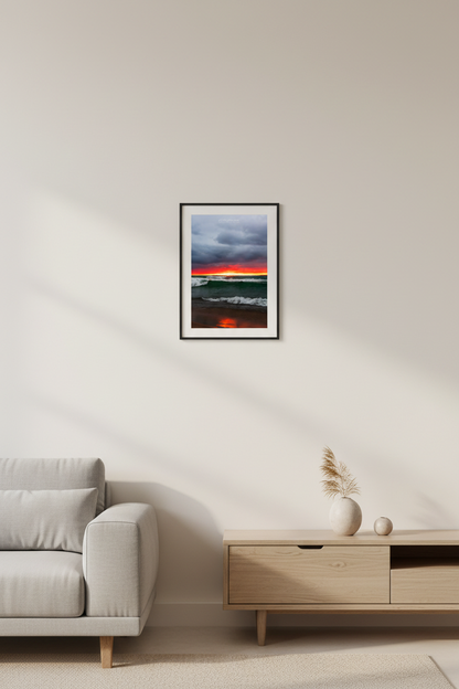 Small fine art portrait print of moody fiery red orange sunset with storm clouds and churning teal waves on Lake Michigan beach Leland Michigan September 2024 displayed in modern living room