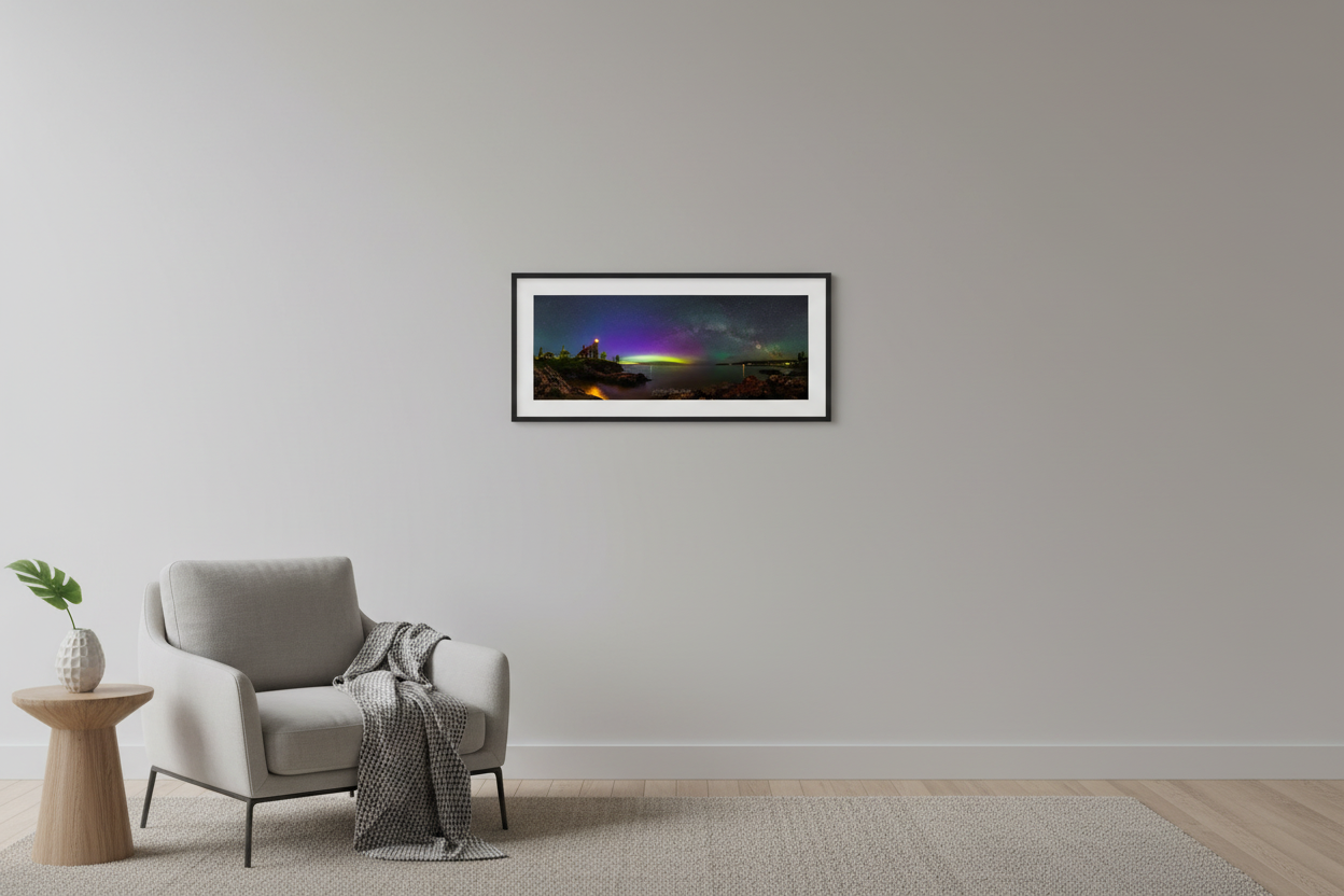 Small fine art 3:1 panoramic print of Milky Way arch and aurora borealis over Eagle Harbor Lighthouse on Lake Superior Keweenaw Peninsula Michigan June 2024 displayed in modern living room