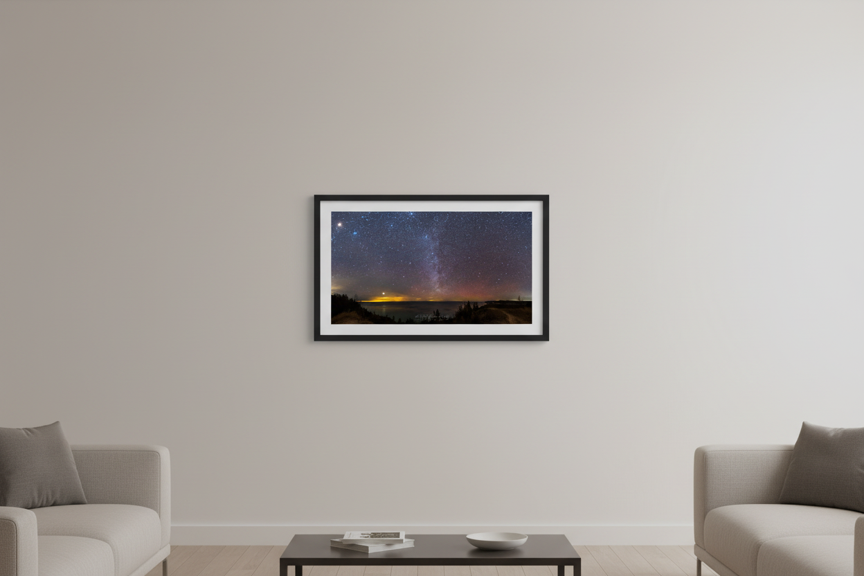 Small fine art 2:1 panorama print of Jupiter and the Winter Milky Way rising over Lake Michigan and the Manitou Islands with red aurora moon glow and silhouetted treeline from Port Oneida Overlook Sleeping Bear Dunes January 15 2023 displayed in modern living room