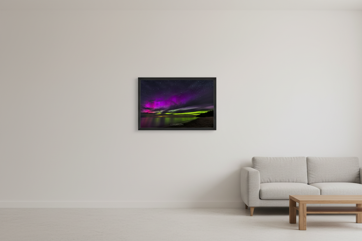 Small fine art landscape print of vivid magenta pink and electric lime green aurora borealis over Lake Michigan from North Street Beach Leland Michigan June 28 2024 displayed in modern living room