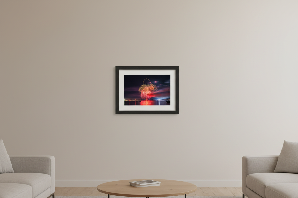 Small fine art landscape print of Traverse City 4th of July 2024 fireworks showing a lush multi-layered gold and pink peony cluster with wild smoke trails above a pink-purple glowing sky over Grand Traverse Bay displayed in modern living room