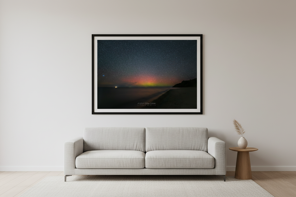 Large fine art print of full spectrum red orange yellow green aurora borealis curtain over Lake Michigan North Street Beach Leland Michigan bright point light on water curved sandy beach dark headland lower right Oct 5 2024 3:18am displayed in modern living room