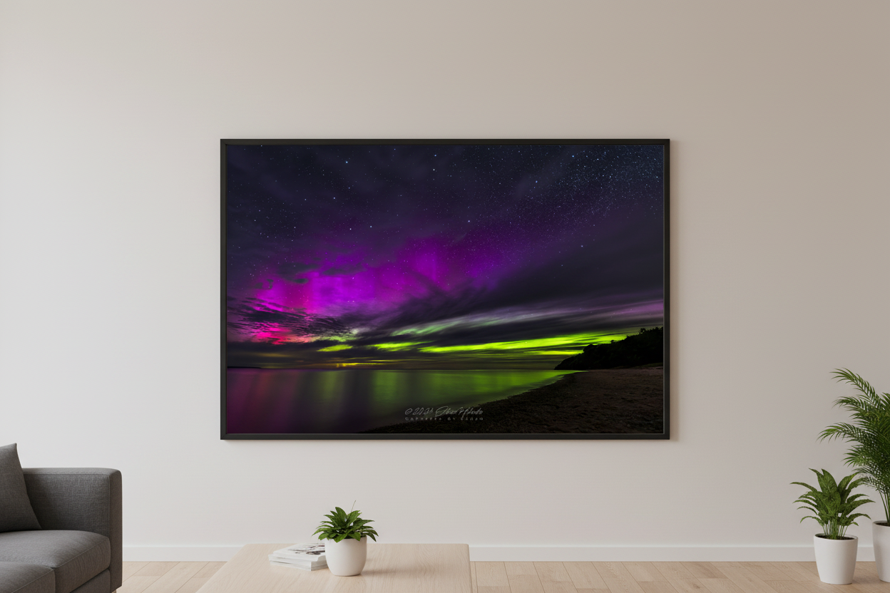 Large fine art landscape print of vivid magenta pink and electric lime green aurora borealis over Lake Michigan from North Street Beach Leland Michigan June 28 2024 displayed in modern living room