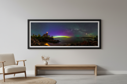 Large fine art 3:1 panoramic print of Milky Way arch and aurora borealis over Eagle Harbor Lighthouse on Lake Superior Keweenaw Peninsula Michigan June 2024 displayed in modern living room