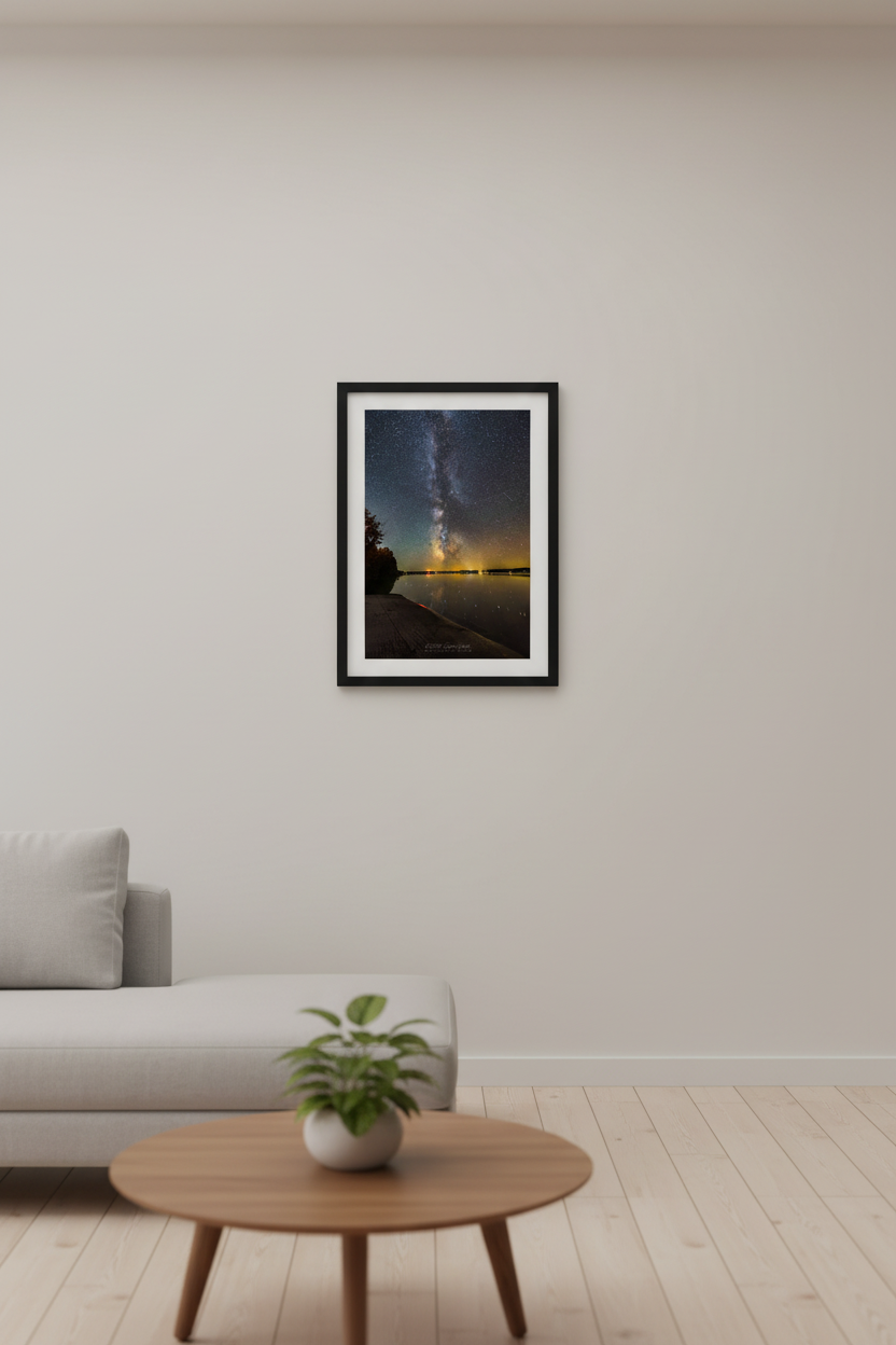 Small fine art portrait print of the Milky Way galactic core rising vertically over calm Lake Leelanau from Suelzer Park Michigan September 28 2024 at 9:42pm with amber gold horizon glow and star reflections on glassy water displayed in modern living room