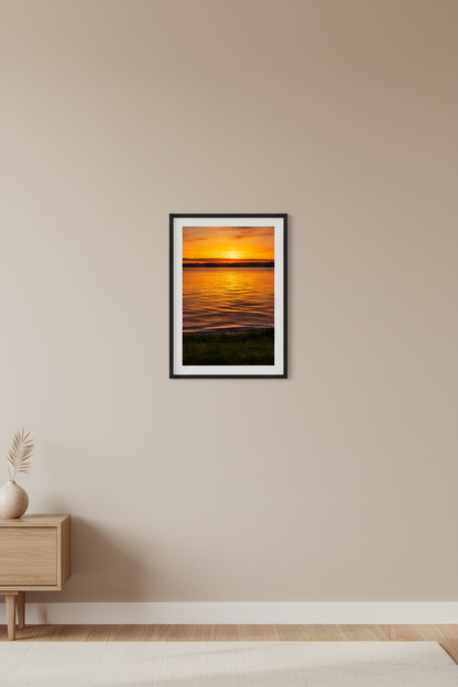 Small fine art portrait print of brilliant golden orange sunrise over calm Lake Leelanau Leland Michigan May 26 2024 displayed in modern living room