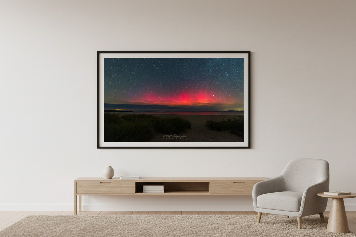 Large fine art print of pure deep crimson red aurora above cloud bank over Lake Michigan from Bohemian Road Beach with sandy dune beach path and dune grass foreground deep teal starfield Sleeping Bear Dunes displayed in modern living room