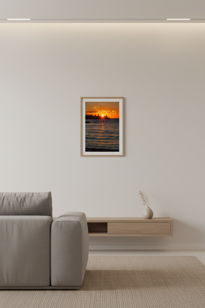 Small fine art portrait print of sunburst sunset over Eagle Harbor Lighthouse Michigan displayed in modern living room