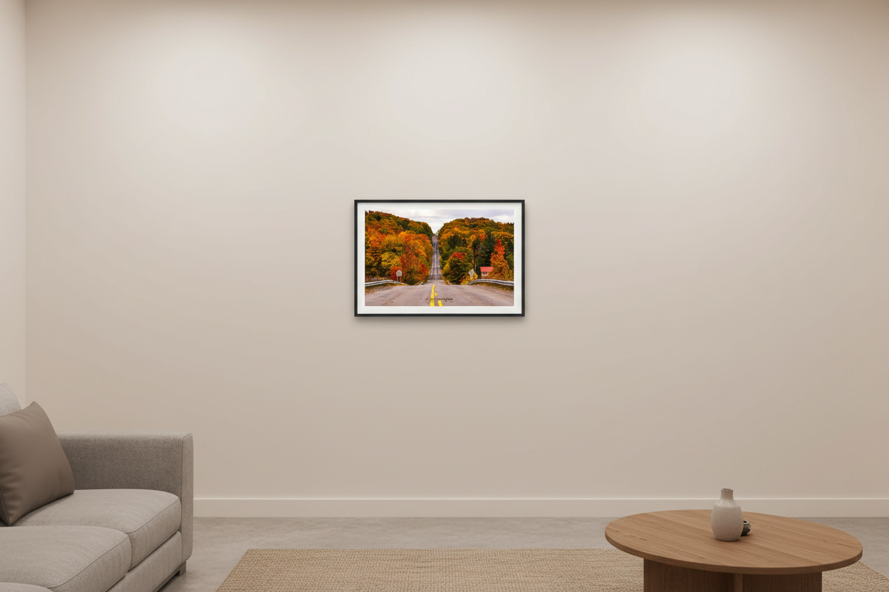 Small fine art landscape print of a road tunneling through peak autumn color in Manistee County Michigan displayed in modern living room