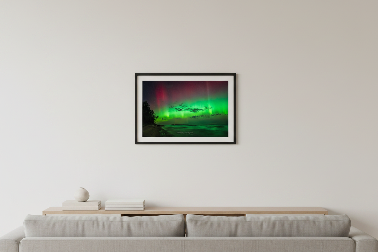 Small fine art landscape print of vivid neon green aurora curtains and crimson red upper aurora with dark cloud bank over Lake Michigan sandy beach shoreline at Port Oneida Sleeping Bear Dunes Michigan October 7 2024 at 10:18pm displayed in modern living room