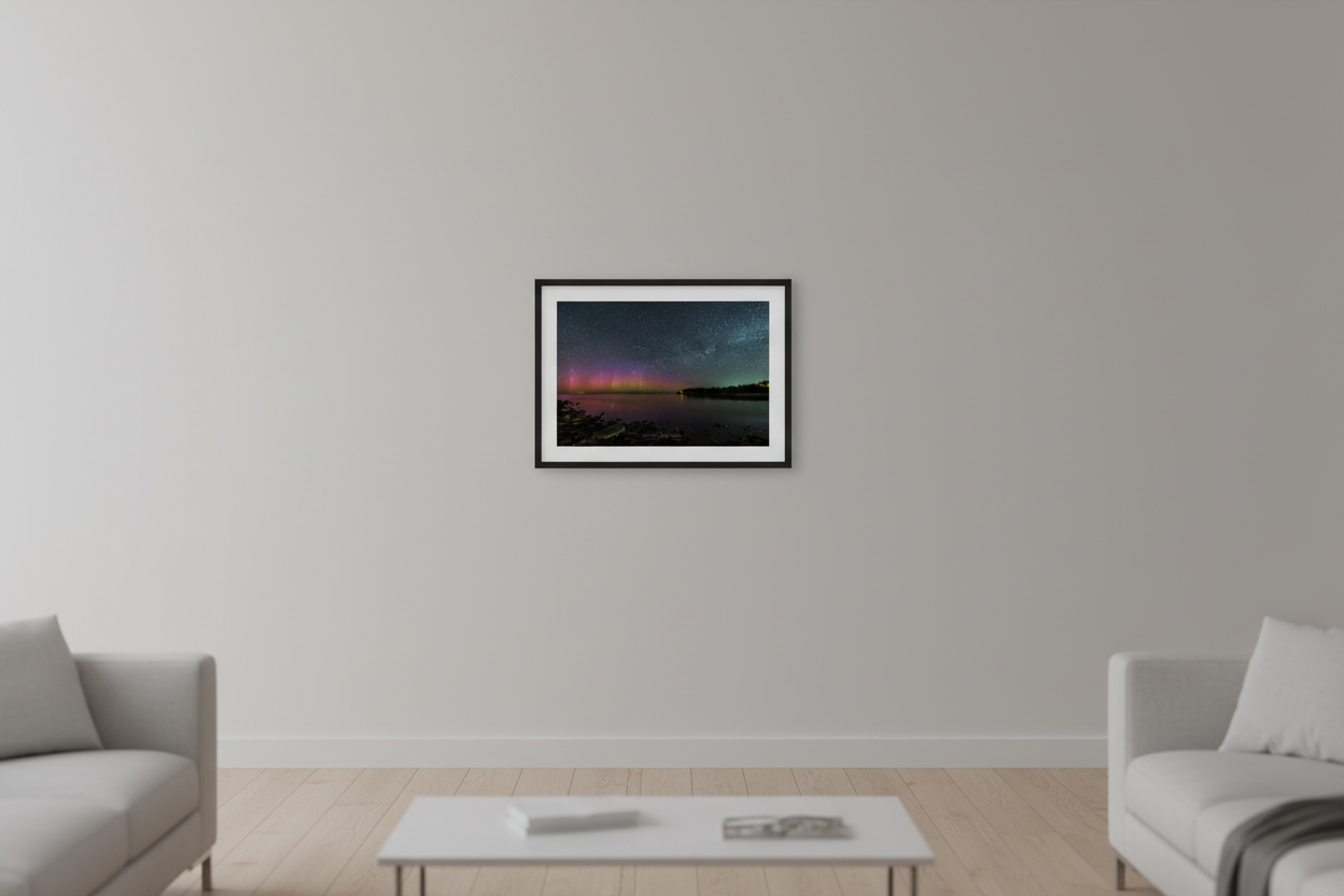 Small fine art landscape print of vivid red magenta and purple Northern Lights aurora borealis dancing over Lake Michigan from Gills Pier Leelanau County Michigan May 6 2024 displayed in modern living room