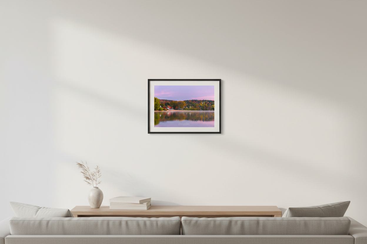 Small fine art landscape print of autumn sunrise reflection over Sutton's Bay Michigan displayed in modern living room