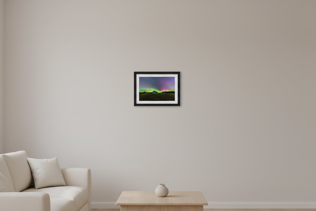 Small fine art landscape print of brilliant green and magenta Northern Lights arching over the historic white D.H. Day Farm barn with cupolas and golden wheat field foreground at Sleeping Bear Dunes Michigan September 4 2022 displayed in modern living room