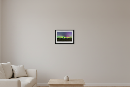 Small fine art landscape print of brilliant green and magenta Northern Lights arching over the historic white D.H. Day Farm barn with cupolas and golden wheat field foreground at Sleeping Bear Dunes Michigan September 4 2022 displayed in modern living room
