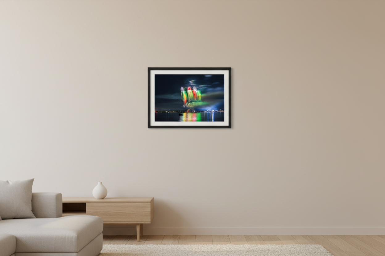 Small fine art landscape print of Traverse City 4th of July 2024 fireworks showing five side-by-side weeping willow shells in green, red, orange, and yellow forming a colorful striped curtain over Grand Traverse Bay displayed in modern living room