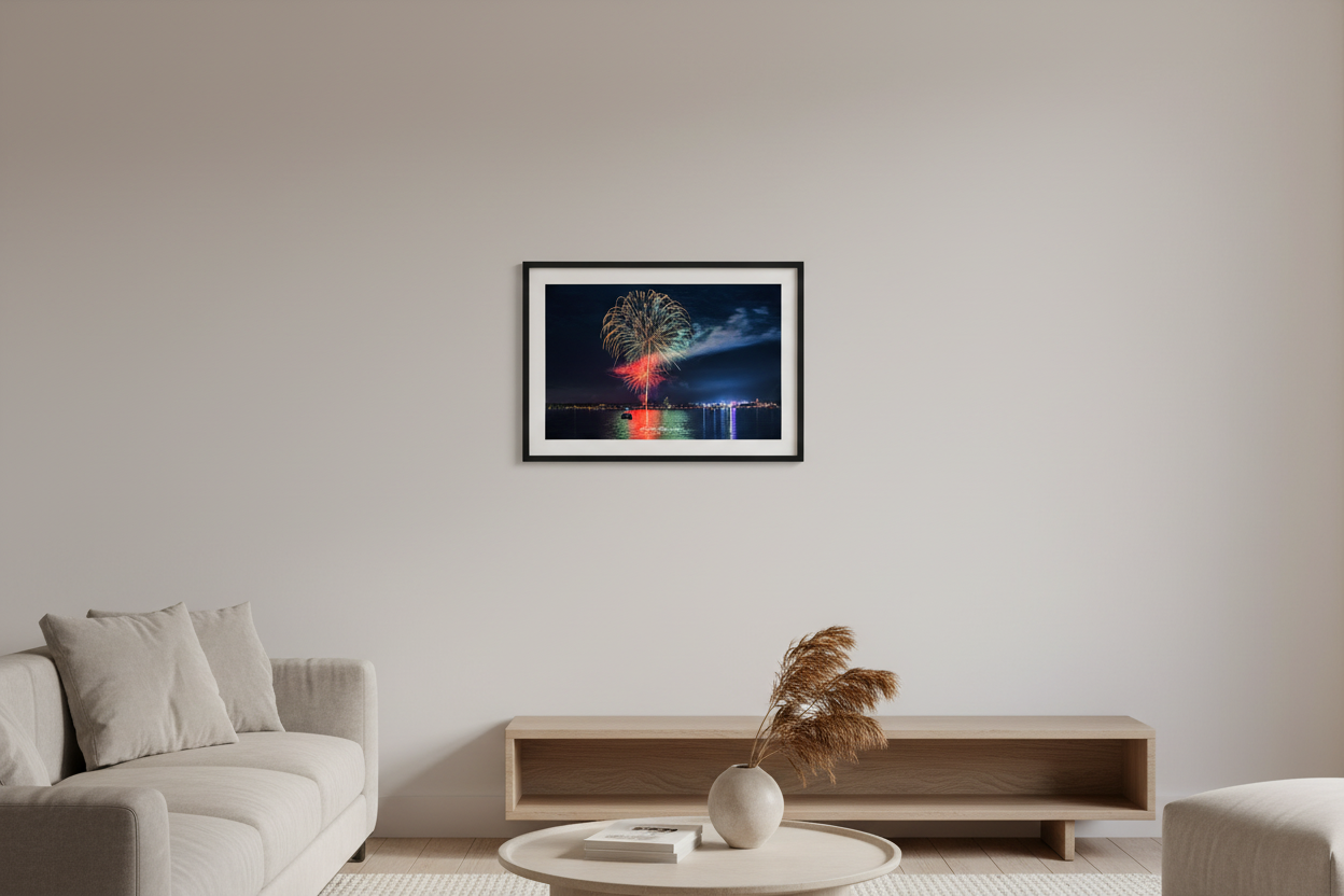 Small fine art landscape print of Traverse City 4th of July 2024 fireworks over Grand Traverse Bay with National Cherry Festival lights and Ferris wheel glow displayed in modern living room