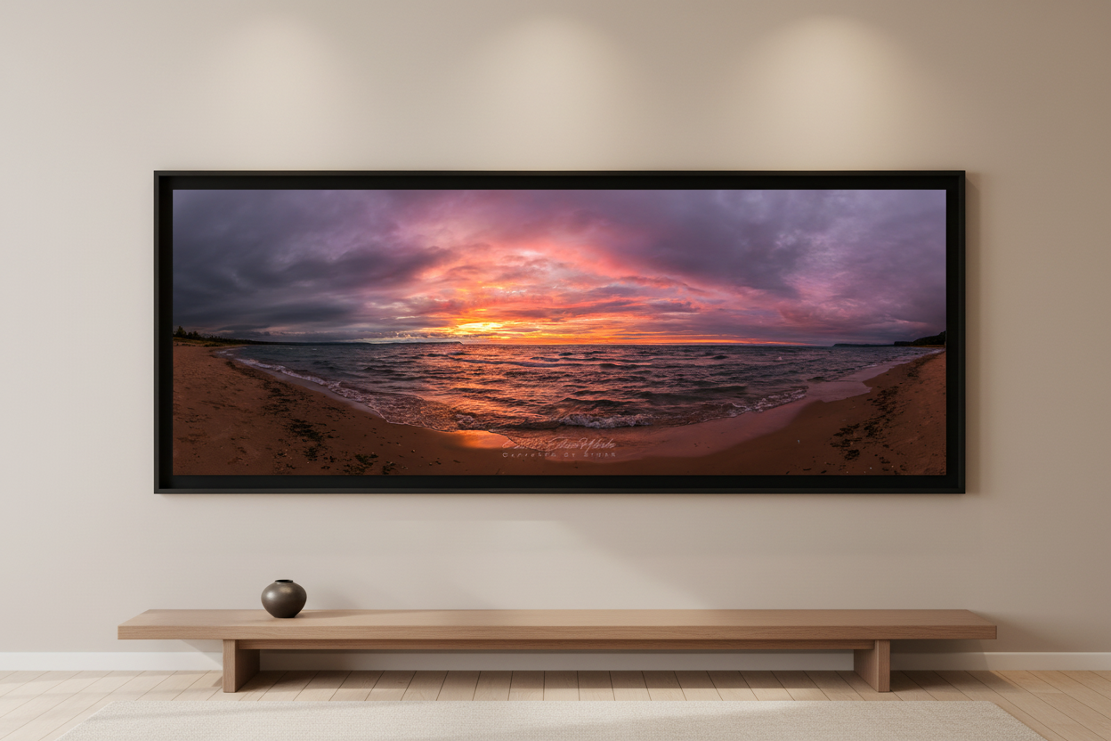Large fine art 3:1 panoramic print of stormy sunset over Good Harbor Beach with fiery orange pink and purple sky over choppy Lake Michigan waters displayed in modern living room