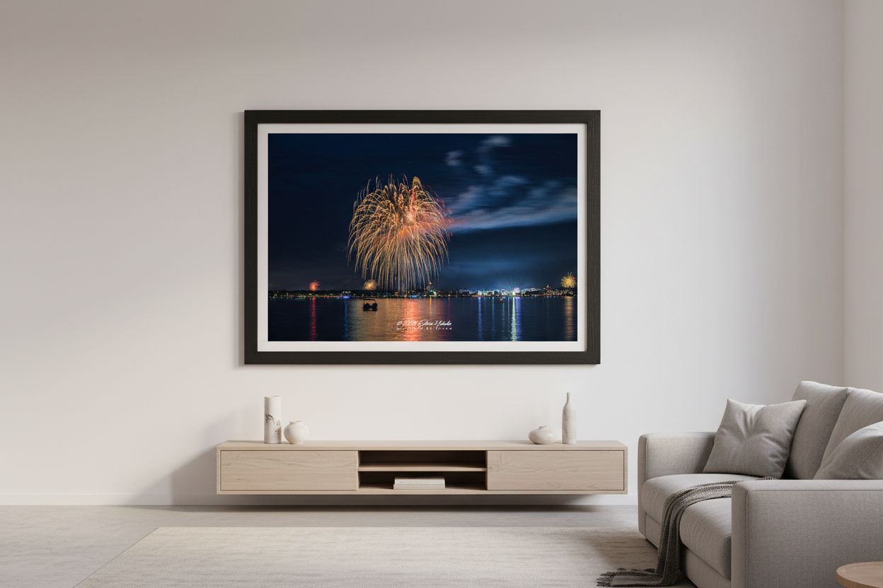 Large fine art landscape print of Traverse City 4th of July 2024 fireworks with golden multi-burst over Grand Traverse Bay and National Cherry Festival Ferris wheel glow displayed in modern living room