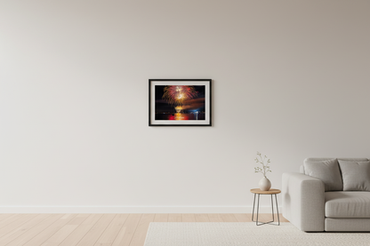 Small fine art landscape print of Traverse City 4th of July 2024 fireworks showing warm gold and crimson chandelier burst with cascading willow trails and rich red-gold water reflection over Grand Traverse Bay displayed in modern living room