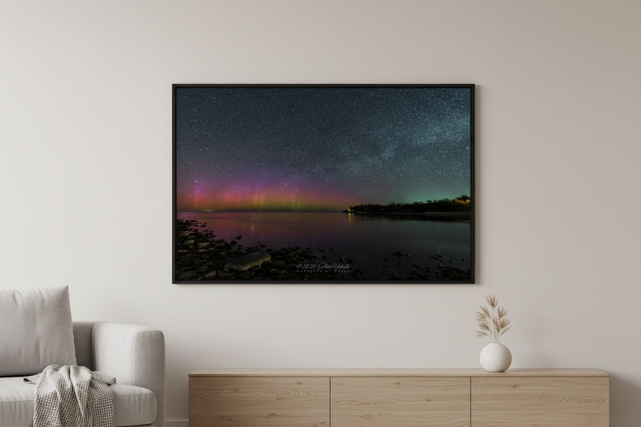 Large fine art landscape print of vivid red magenta and purple Northern Lights aurora borealis dancing over Lake Michigan from Gills Pier Leelanau County Michigan May 6 2024 displayed in modern living room