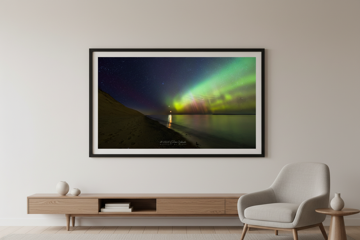 Large fine art landscape print of green and yellow-green Northern Lights aurora curtains over Lake Michigan with moon reflection and sandy bluff at Sleeping Bear Dunes Michigan March 23 2023 at 10:19pm displayed in modern living room