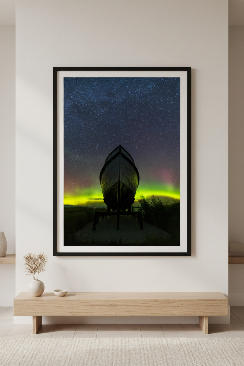 Large fine art portrait print of the historic Aloha Boat silhouetted against vivid neon green and pink aurora borealis in Glen Haven Michigan Sleeping Bear Dunes September 4 2022 displayed in modern living room