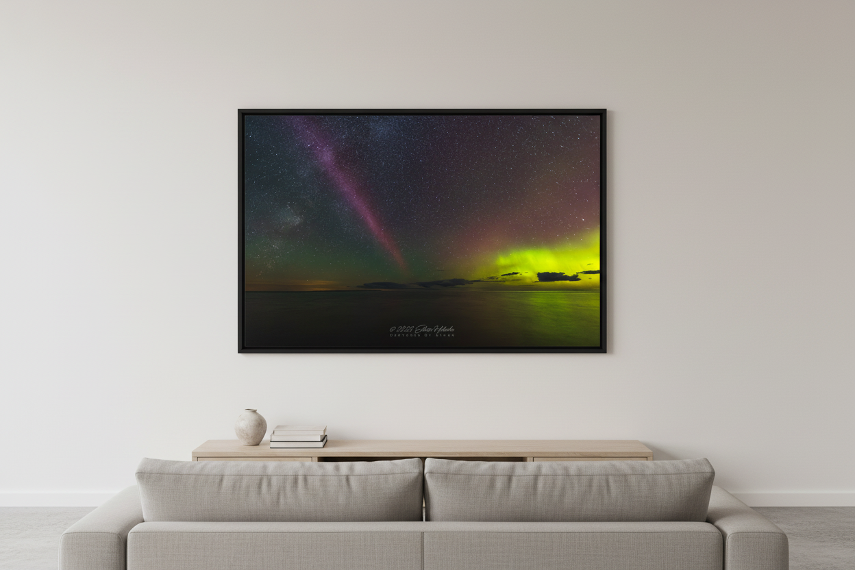 Large fine art landscape print of S.T.E.V.E. aurora and Milky Way together over Lake Michigan at Christmas Cove Beach Northport Michigan September 19 2023 at 12:10am with crimson pink aurora pillar and electric green aurora glow reflecting on calm water displayed in modern living room