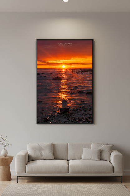 Large fine art portrait print of blazing sunrise over Grand Traverse Bay rocky shoreline from Leelanau State Park Michigan September 2023 displayed in modern living room