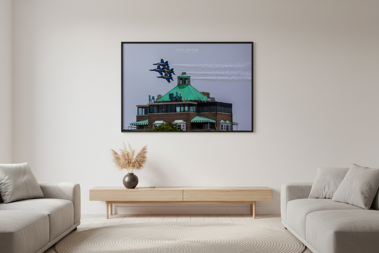 Large fine art landscape print of Blue Angels F/A-18 Hornets in tight diamond formation flying just above the green copper roof of the Park Place Hotel in Traverse City during the 2024 Cherry Festival Airshow displayed in modern living room