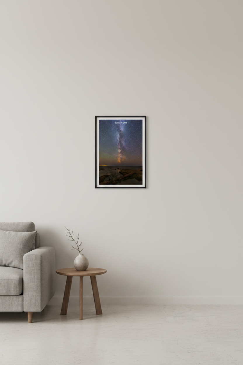 Small fine art portrait print of the Milky Way core rising vertically over the rocky shoreline at the mouth of the Cut River Michigan Upper Peninsula with meteor and warm horizon glow August 27 2022 displayed in modern living room