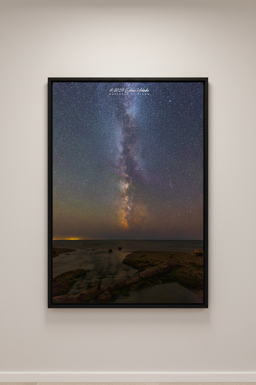 Large fine art portrait print of the Milky Way core rising vertically over the rocky shoreline at the mouth of the Cut River Michigan Upper Peninsula with meteor and warm horizon glow August 27 2022 displayed in modern living room