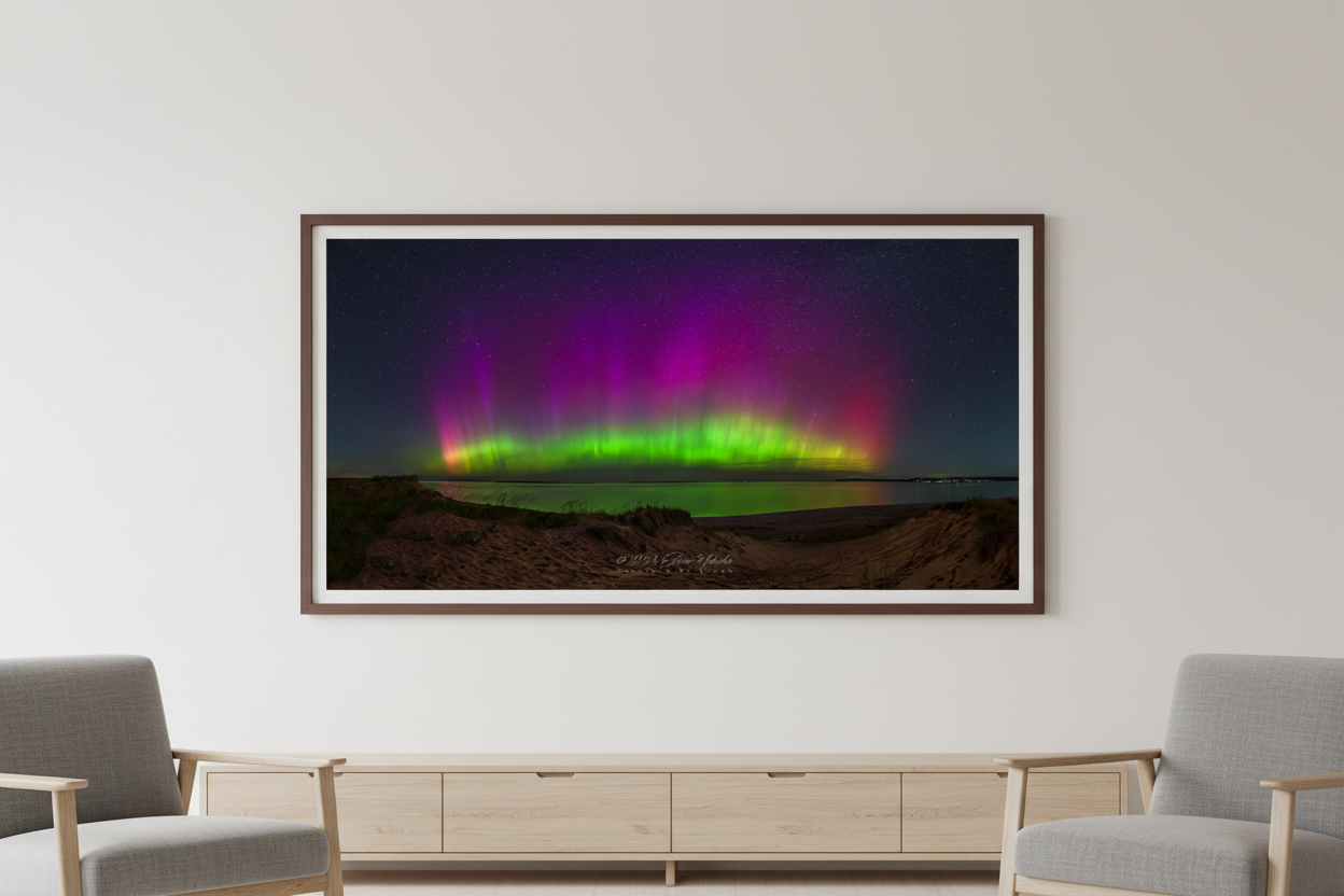 Large fine art wide panorama print of northern lights over Lake Michigan from Sleeping Bear Point displayed in modern living room