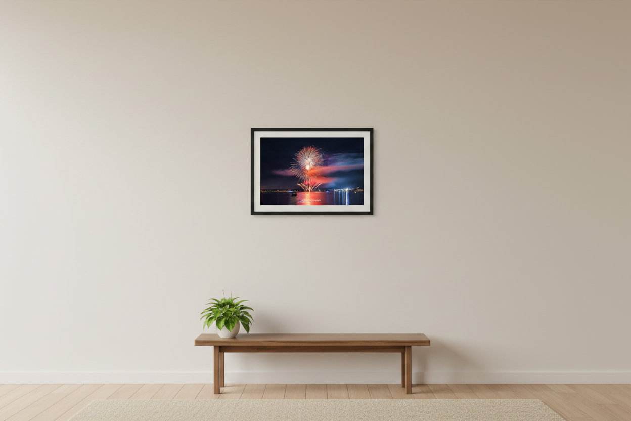 Small fine art landscape print of Traverse City 4th of July 2024 fireworks with dramatic pink smoke cloud and symmetrical golden mortar fans over Grand Traverse Bay displayed in modern living room