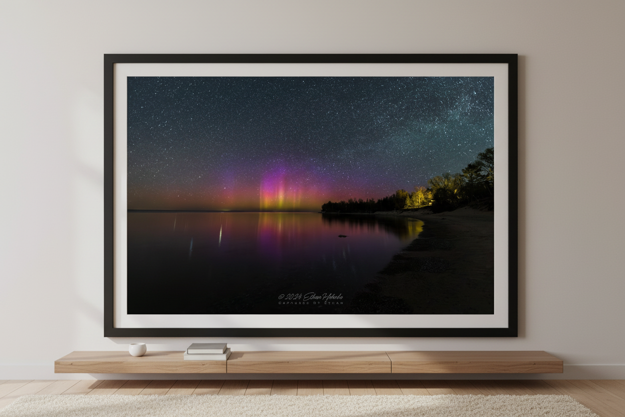 Large fine art landscape print of vivid yellow-green magenta and purple Northern Lights aurora borealis pillars reflecting in calm Lake Michigan from Gills Pier Leelanau County Michigan May 6 2024 displayed in modern living room
