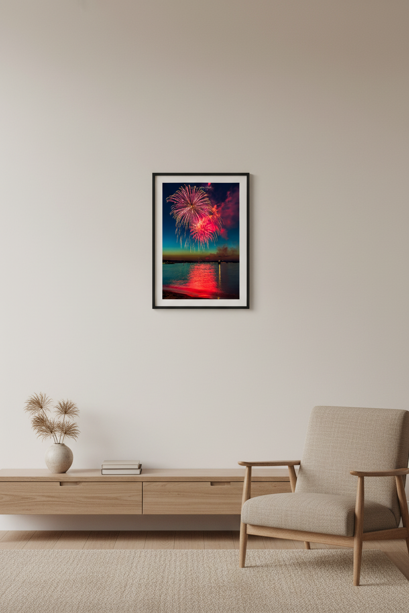 Small fine art portrait print of Traverse City Cherry Festival 2024 finale fireworks with pink and magenta bursts reflecting over Grand Traverse Bay from Clinch Park Beach displayed in modern living room