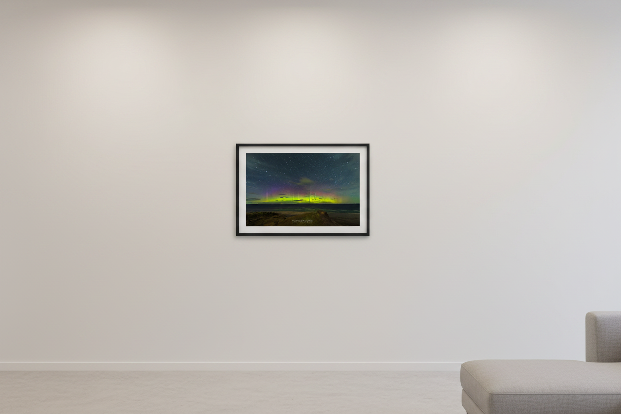 Small fine art landscape print of vivid yellow-green aurora pillars and purple magenta band over Lake Michigan from elevated beach overlook at Sleeping Bear Dunes Michigan September 3 2022 displayed in modern living room