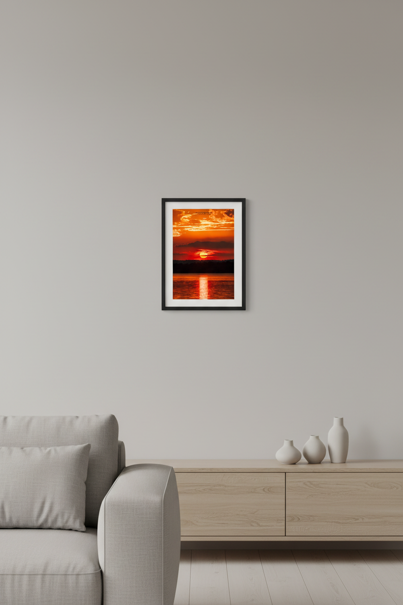 Small fine art portrait print of summer solstice sunrise with full sun over Lake Leelanau Michigan displayed in modern living room