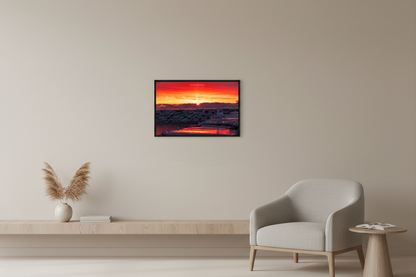 Small fine art landscape print of sun pillar sunset over icy breakwall in Leland, Lake Michigan displayed in modern living room
