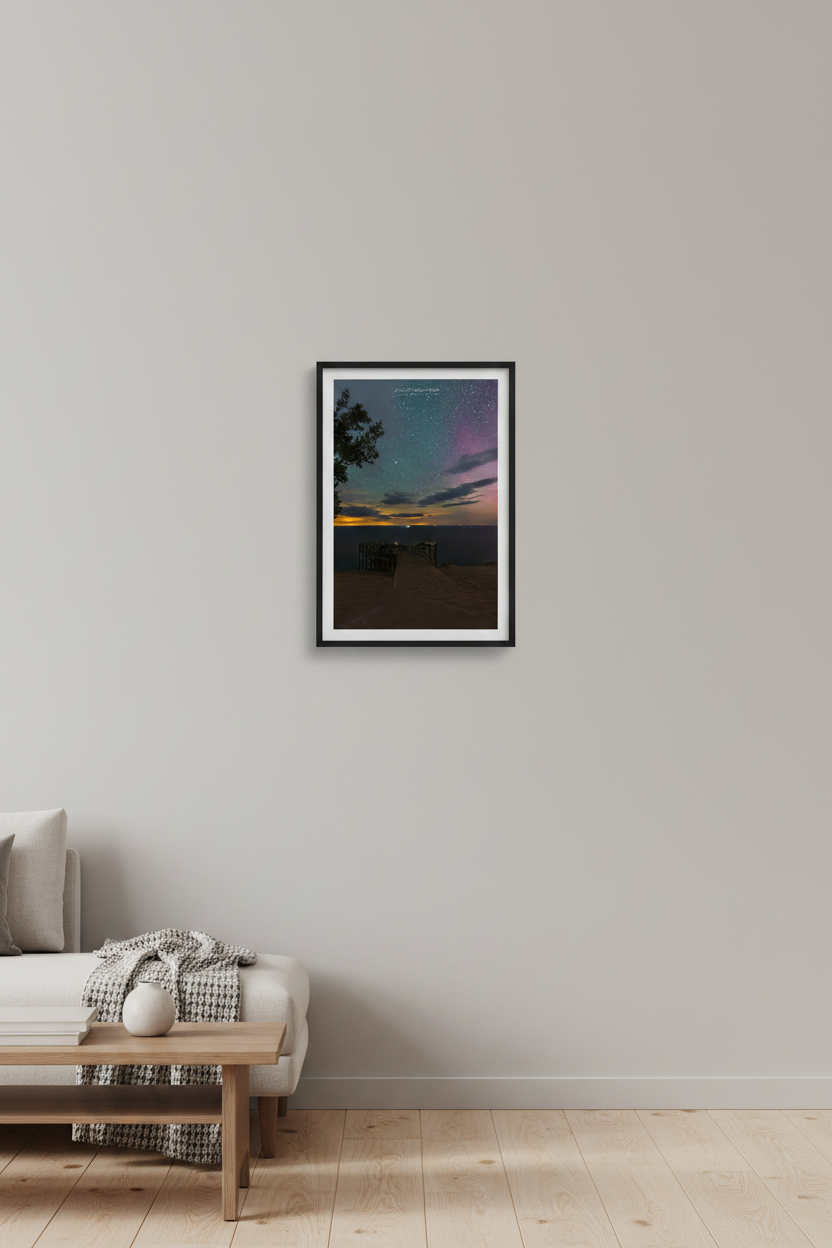 Small fine art portrait print of starry night sky with aurora glow from the historic Overlook 9 at Sleeping Bear Dunes Michigan July 23 2022 with golden horizon and purple aurora displayed in modern living room