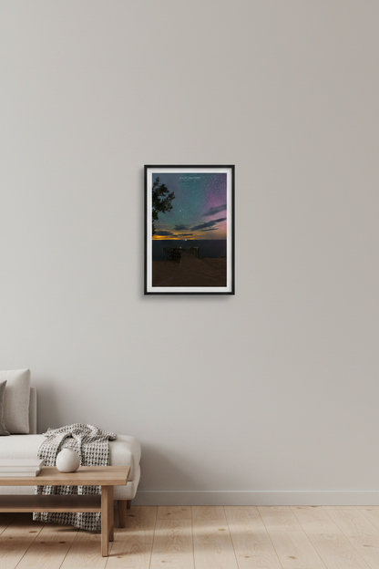Small fine art portrait print of starry night sky with aurora glow from the historic Overlook 9 at Sleeping Bear Dunes Michigan July 23 2022 with golden horizon and purple aurora displayed in modern living room
