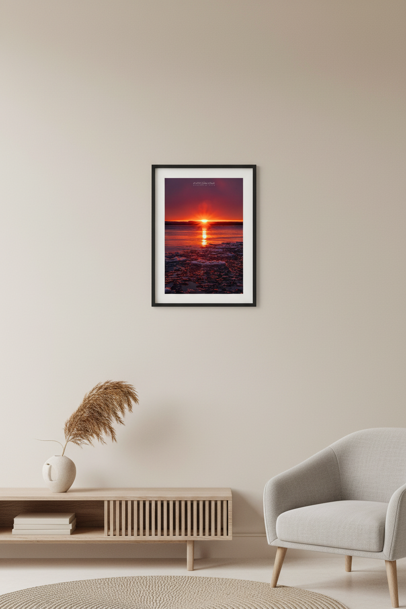 Small fine art portrait print of blazing crimson sunrise with glowing pancake ice floes on Good Harbor Bay Michigan February 2023 displayed in modern living room