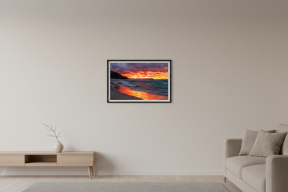 Small fine art landscape print of blazing crimson and orange November fire sunset with glowing ember-like clouds fiery reflection across wet sandy beach turquoise-teal churning waves dark forested bluff and distant Sleeping Bear Dunes headland at Leland Lake Michigan November 30 2021 displayed in modern living room