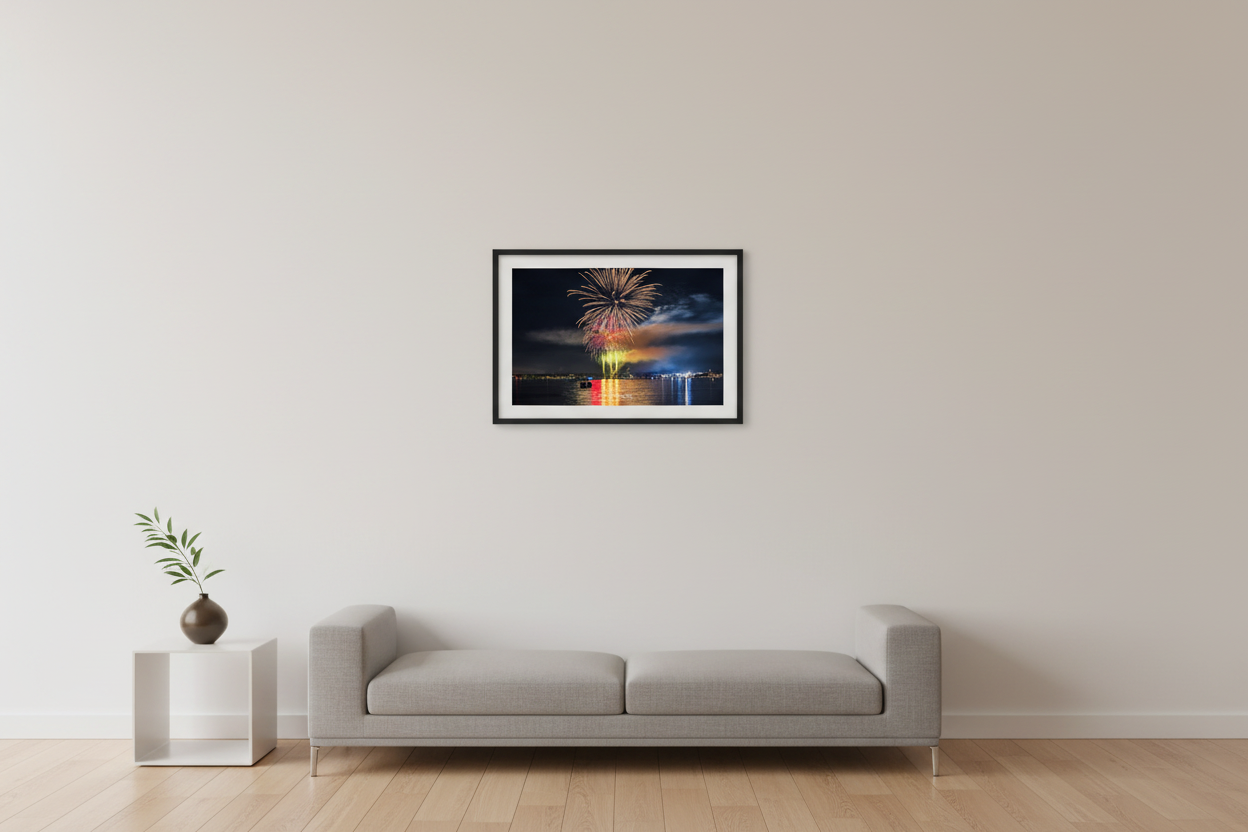 Small fine art landscape print of Traverse City 4th of July 2024 fireworks with tall golden launch columns, rainbow smoke base, and colorful multi-stage burst over Grand Traverse Bay displayed in modern living room