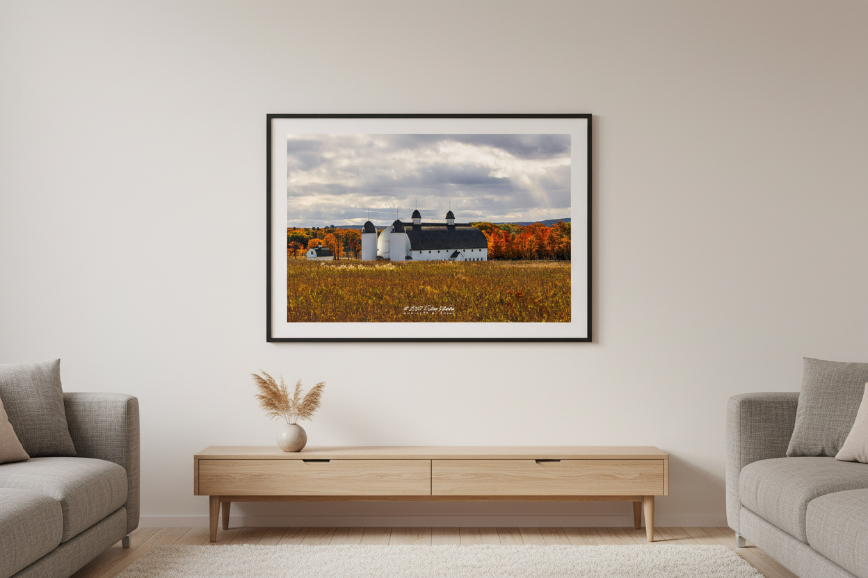 Large fine art landscape print of D.H. Day Farm white barn with autumn foliage at Sleeping Bear Dunes displayed in modern living room