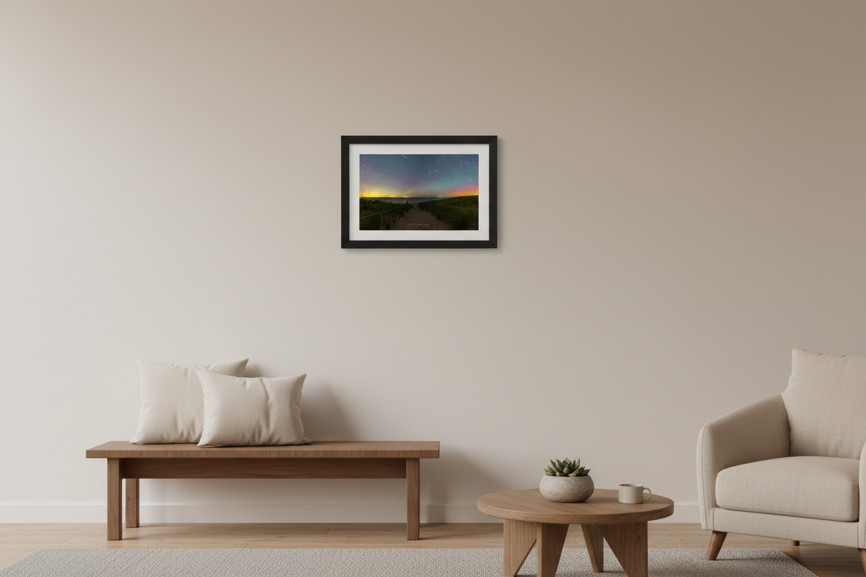 Small fine art landscape print of starry night sky with warm horizon glow subtle aurora and meteor above North Bar Lake beach trail rope fence Sleeping Bear Dunes Lake Michigan August 31 2022 displayed in modern living room