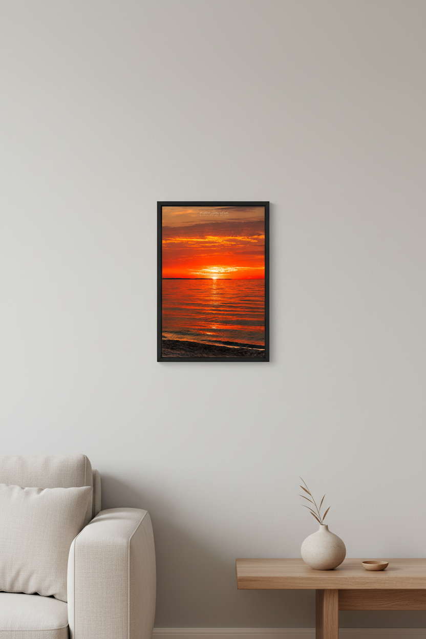 Small fine art portrait print of deep crimson orange sunset with golden reflection path across glassy calm Lake Michigan water Leland Michigan September 2024 displayed in modern living room