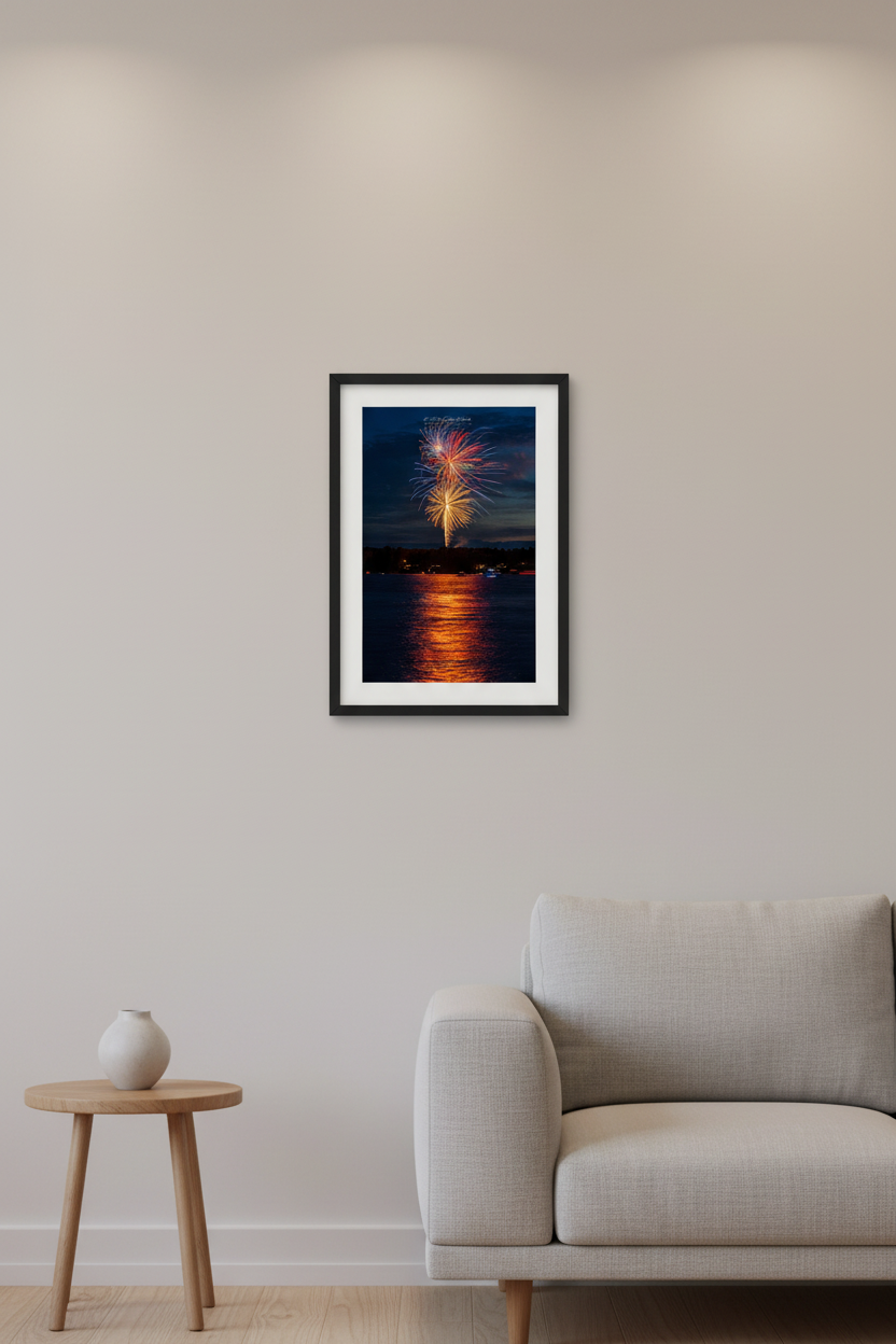 Small fine art portrait print of colorful fireworks bursting over Lake Leelanau Leland Michigan 4th of July July 3 2024 with golden reflection on water displayed in modern living room