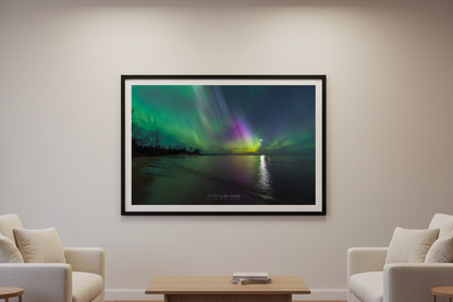 Large fine art landscape print of vivid green and magenta aurora curtains with Moon and Venus reflecting over Misery Bay Lake Superior Michigan Upper Peninsula April 24 2023 displayed in modern living room
