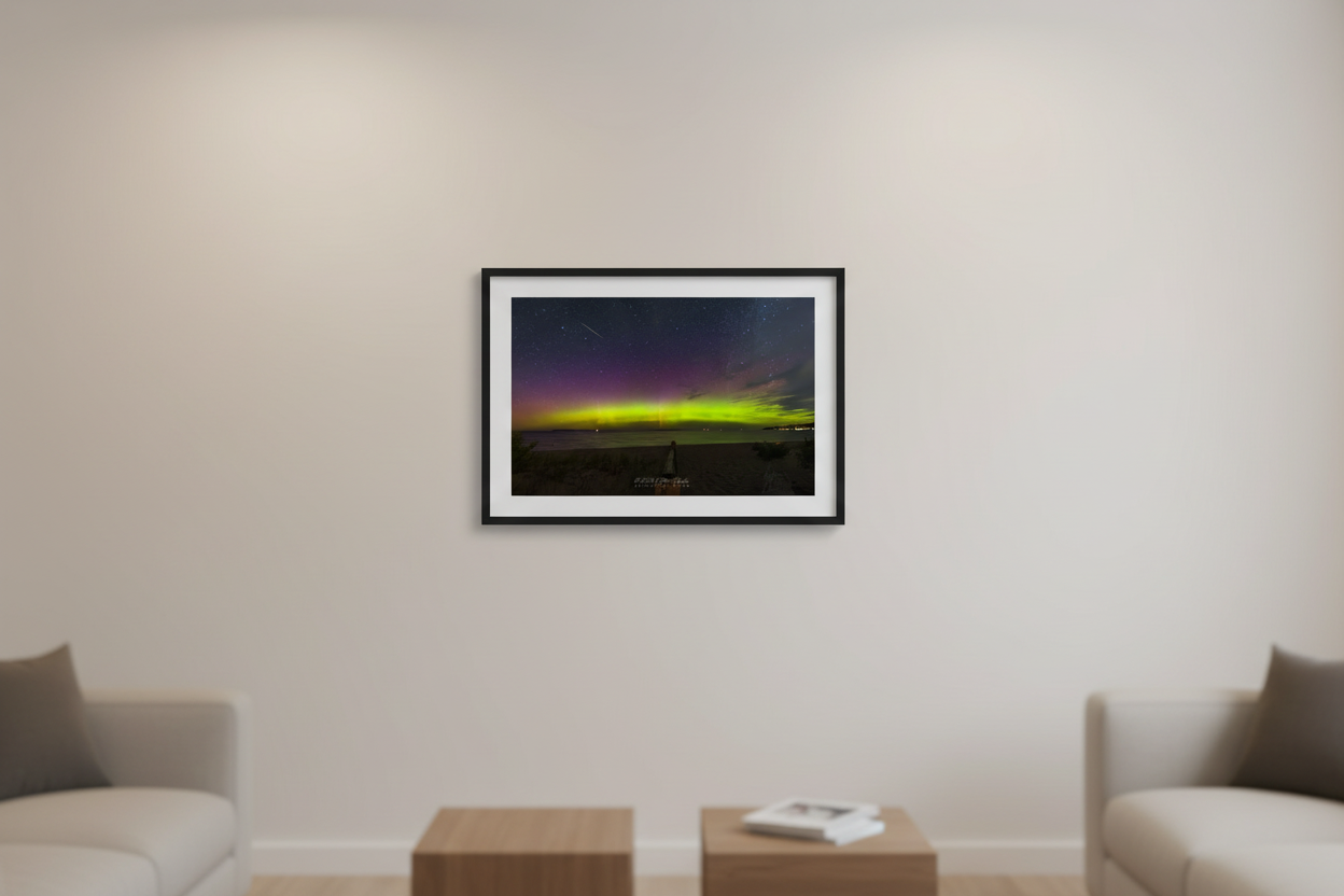 Small fine art print of wide panoramic lime green and purple Northern Lights aurora over Lake Michigan from Glen Arbor open beach with boardwalk meteor streak and distant town lights displayed in modern living room